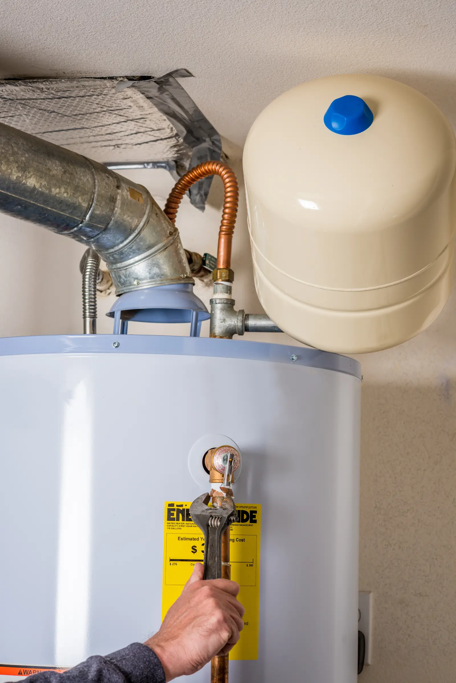Water heater installed in an attic with drain pan &mdash; the two-floors-up failure risk Frisco, TX two-story homes manage