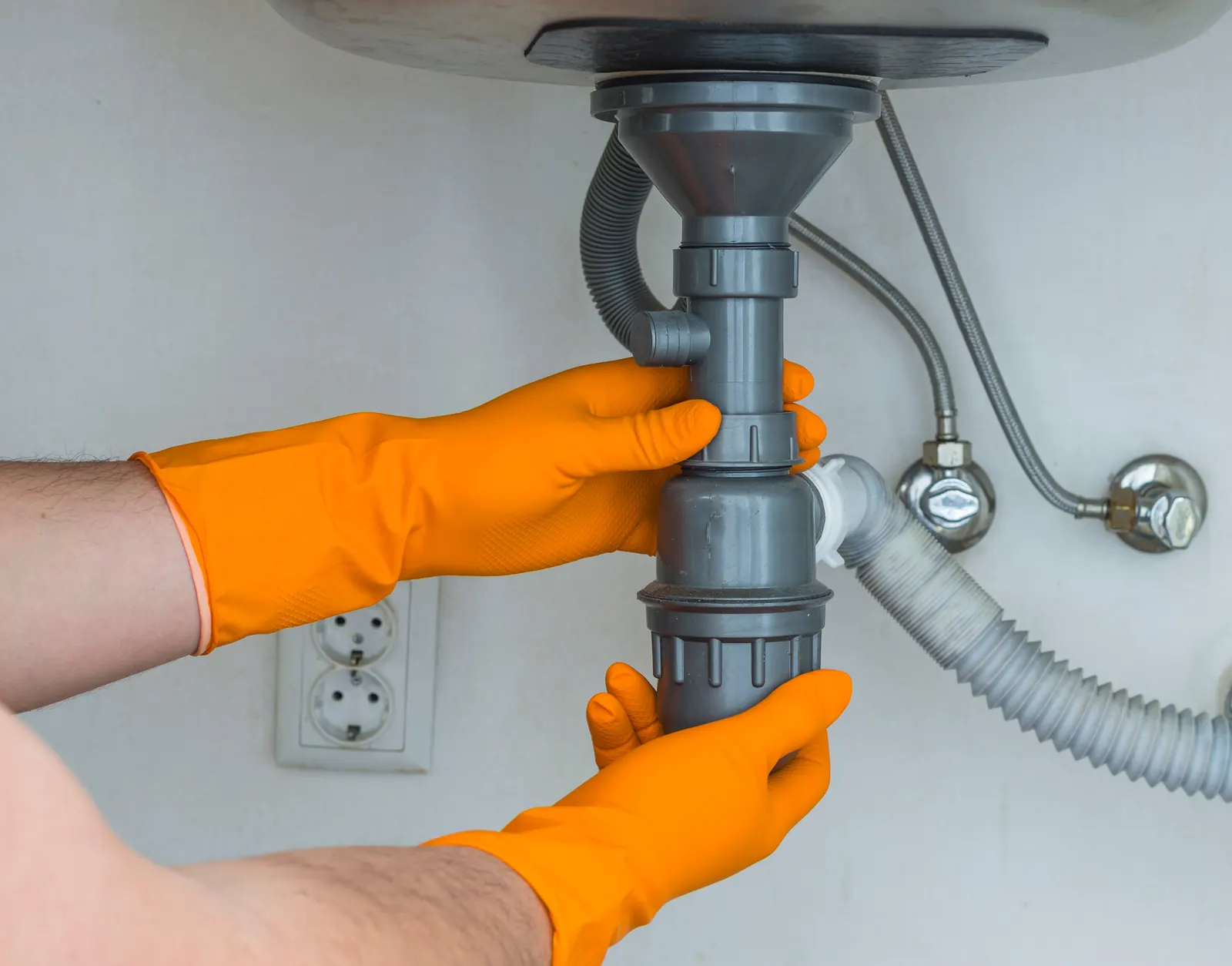 Clogged sink being cleared &mdash; August lease-turnover season makes drain calls a rhythm of the year in Nacogdoches, TX