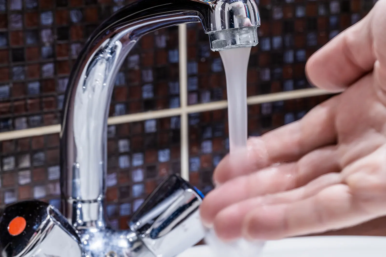 Bathroom faucet running at visibly low pressure, the classic symptom of original galvanized supply in Texas City's mid-century core