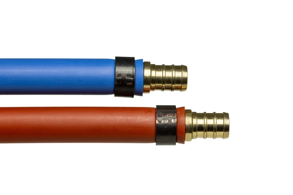 Blue and red PEX water piping used in whole-house repipes, the material that replaces failing supply lines in Austin homes