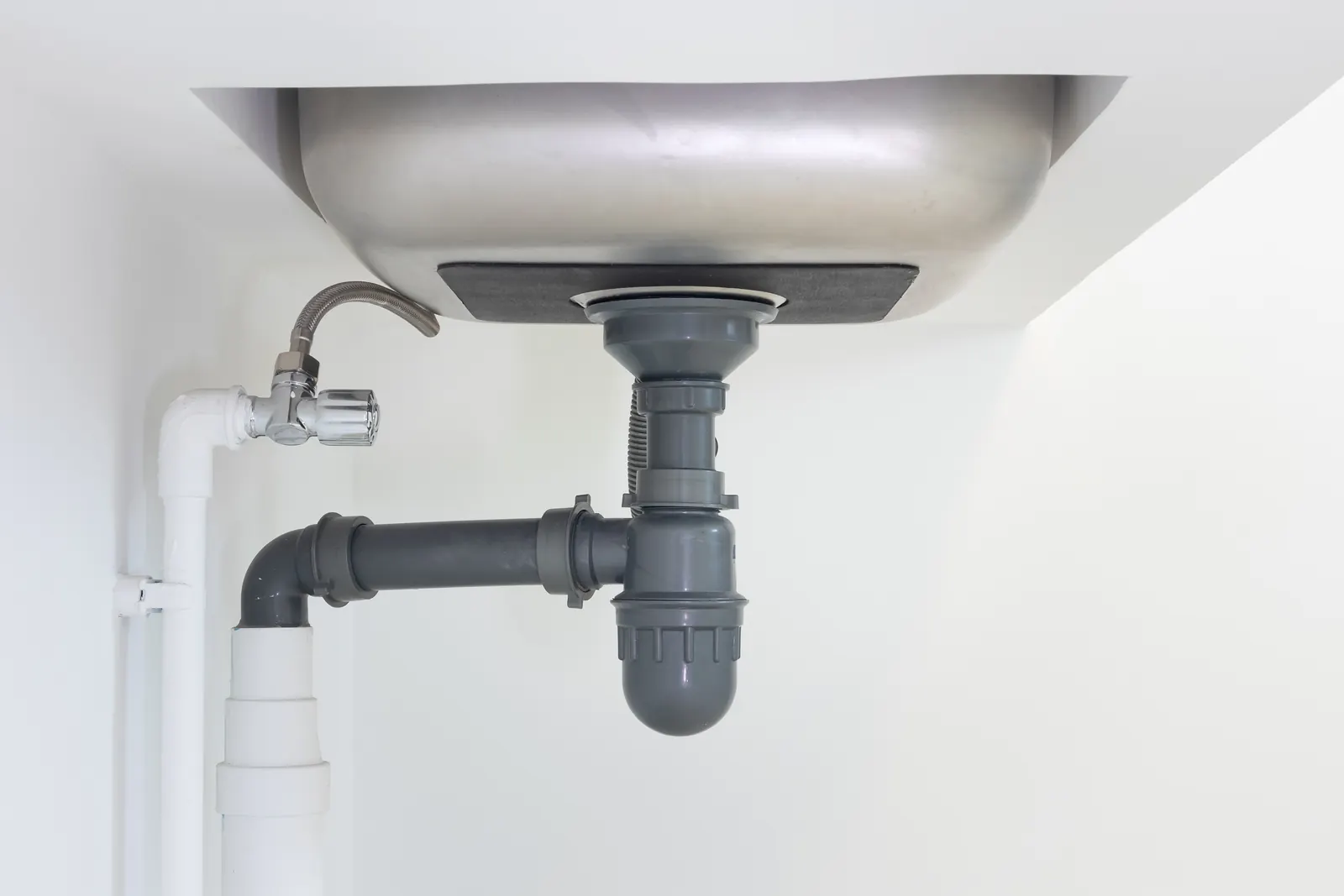 Illustration of tracing a sewer odor to a dry sink trap, the vintage-drain diagnosis common in Sherman's century-old grid