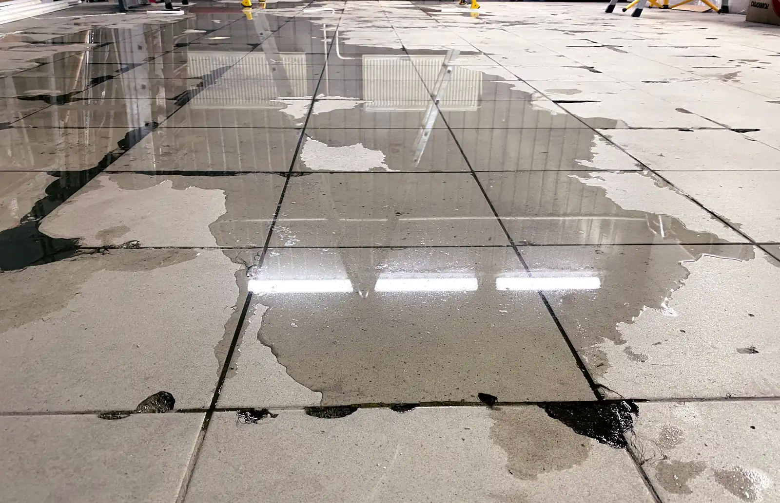Flooded floor from an under-slab line failure — cohort-wave copper makes slab leaks Plano, TX’s signature call