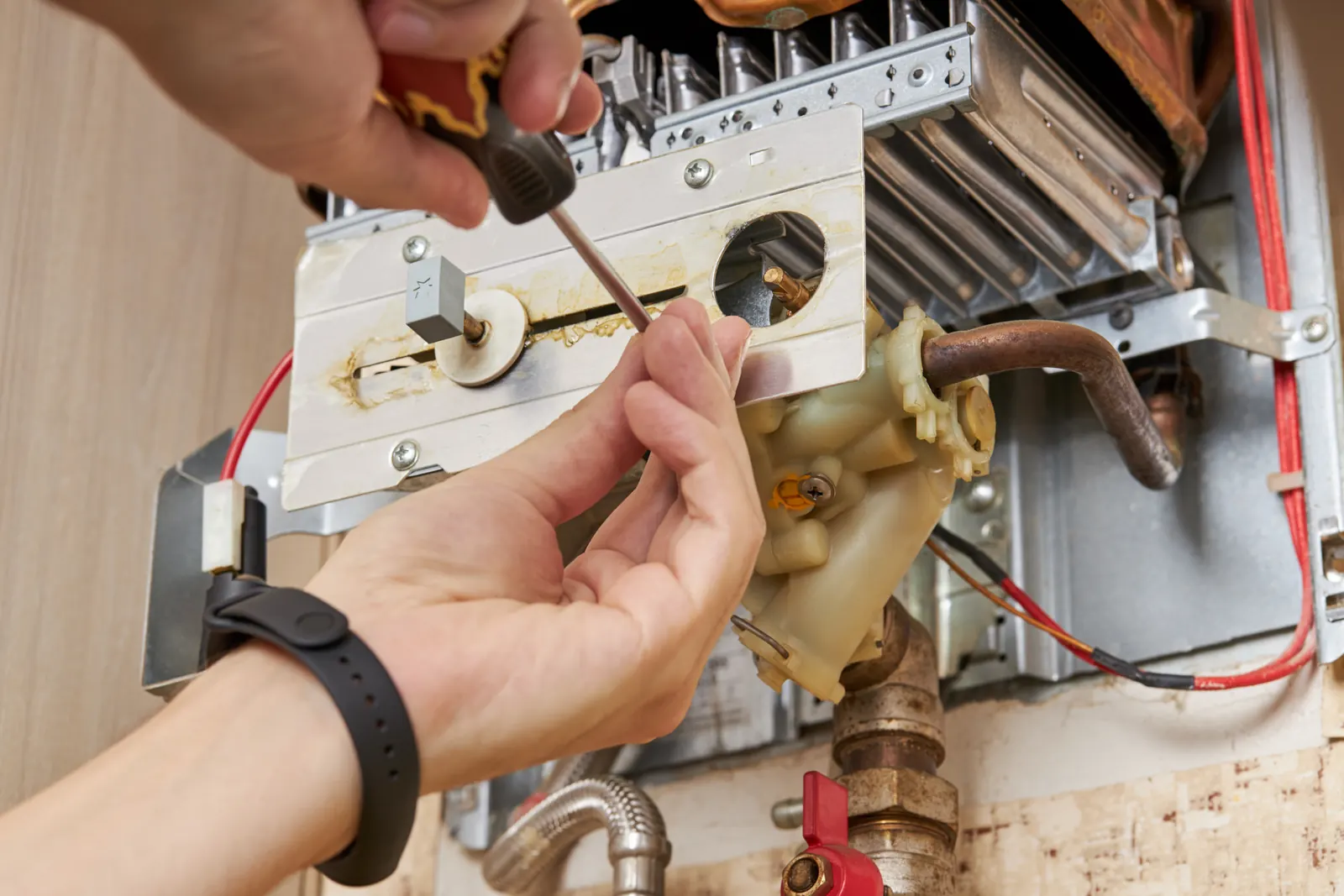 Licensed plumber servicing a water heater — garage and closet installs shape Fort Worth, TX heater repair calls